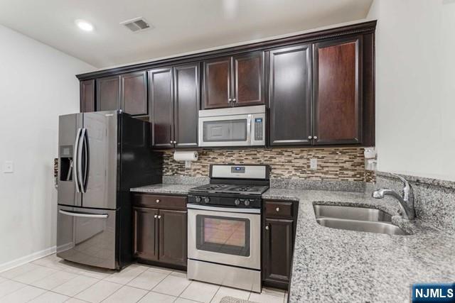 22 Veterans Drive Wood-Ridge, NJ 07075 - Photo 13 of 49 a kitchen with granite countertop stainless steel appliances and cabinets
