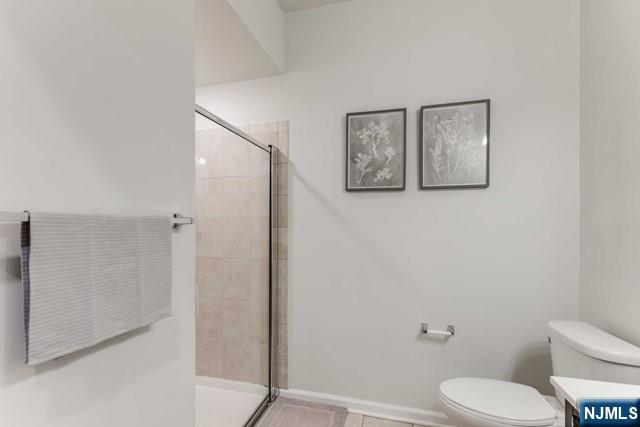 22 Veterans Drive Wood-Ridge, NJ 07075 - Photo 17 of 49 a white toilet sitting next to a bathroom sink