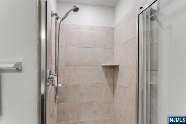 22 Veterans Drive Wood-Ridge, NJ 07075 - Photo 19 of 49 a bathroom with a glass shower door