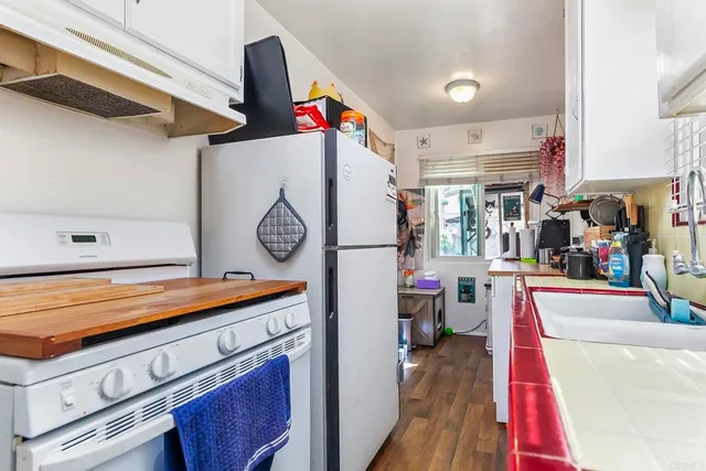 a kitchen with cabinets appliances and a window