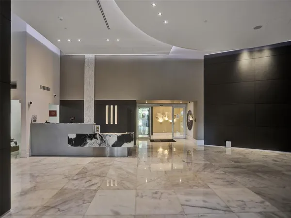 a lobby with furniture and a view of bathroom
