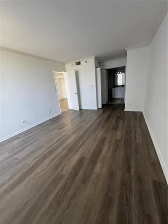 a view of wooden floor and windows in a room