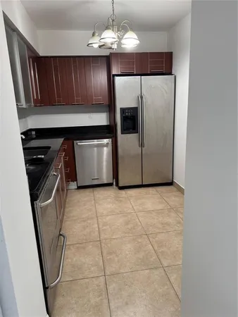 a kitchen with a stove a refrigerator and cabinets