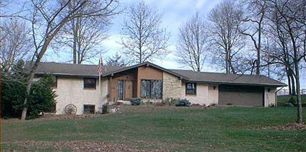 8530 North Creek Road Roscoe, IL 61073 - Photo 1 of 6 a front view of a house with a garden and trees