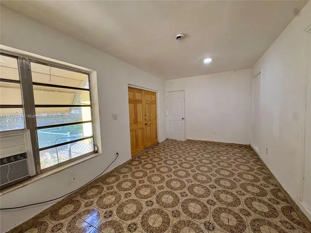 a kitchen with granite countertop a refrigerator and a sink
