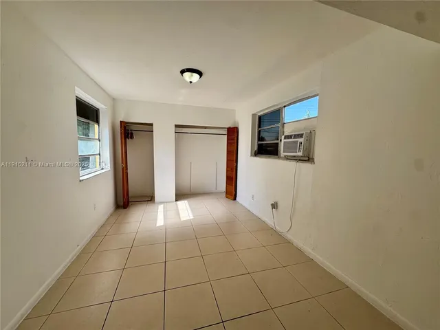 a view of a kitchen with furniture and an empty room