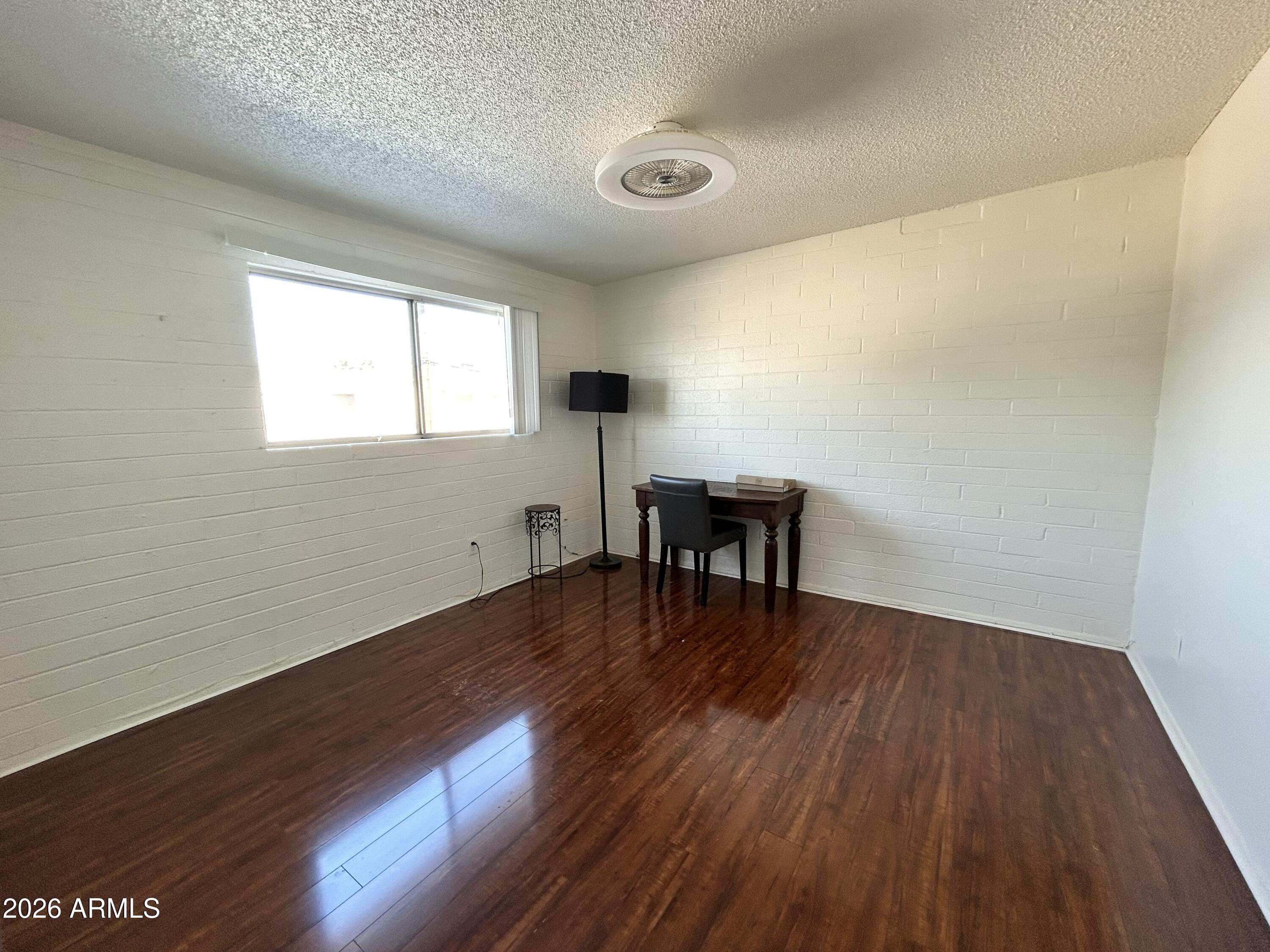 6565 North 19th Avenue, Unit 27 Phoenix, AZ 85015 - Photo 12 of 17 wooden floor in an empty room with a window