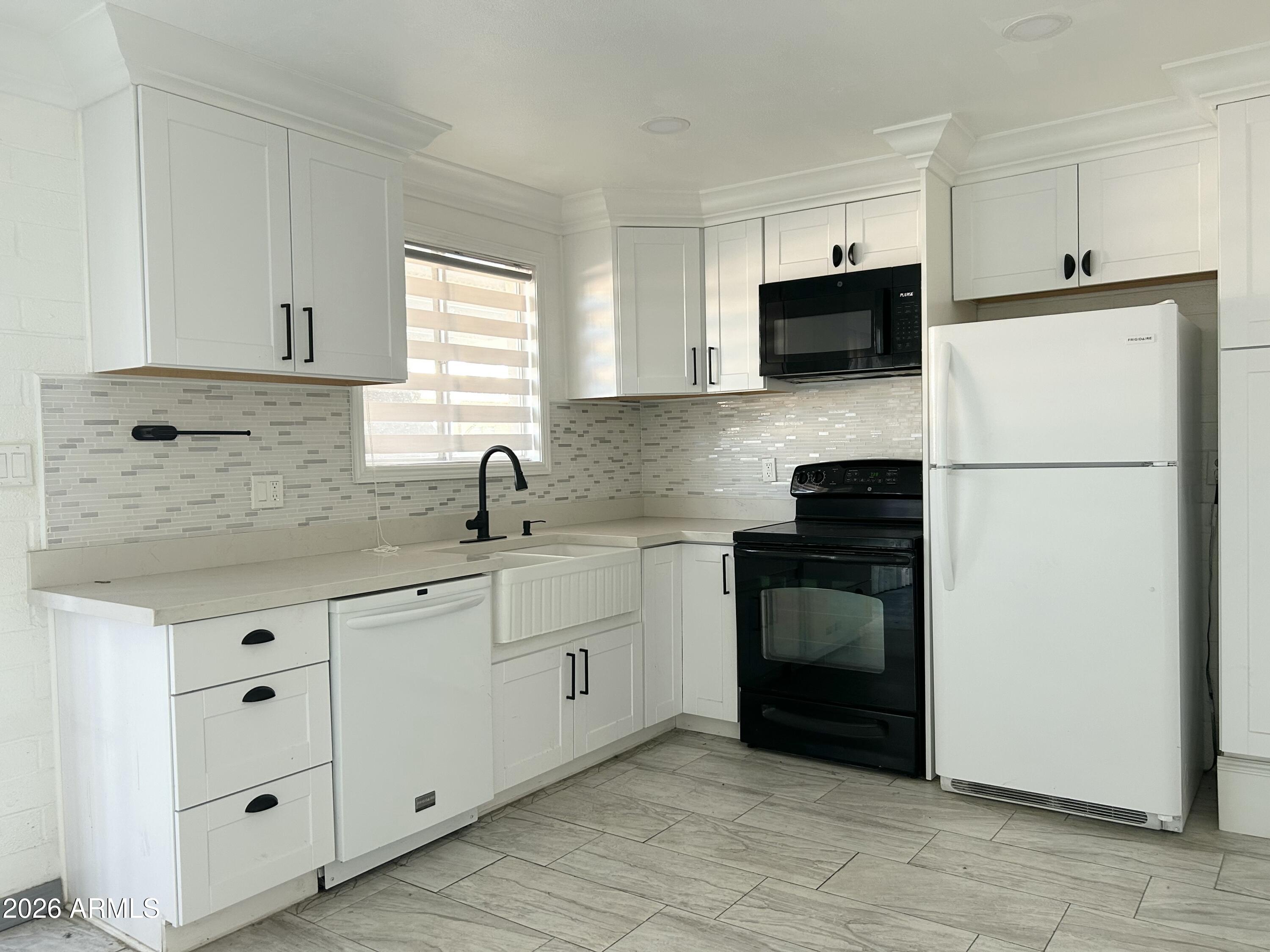 6565 North 19th Avenue, Unit 27 Phoenix, AZ 85015 - Photo 3 of 17 a kitchen with granite countertop white cabinets and stainless steel appliances
