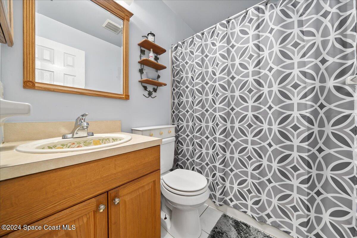 5536 Flint Road Cocoa, FL 32927 - Photo 9 of 15 a bathroom with a sink and a toilet