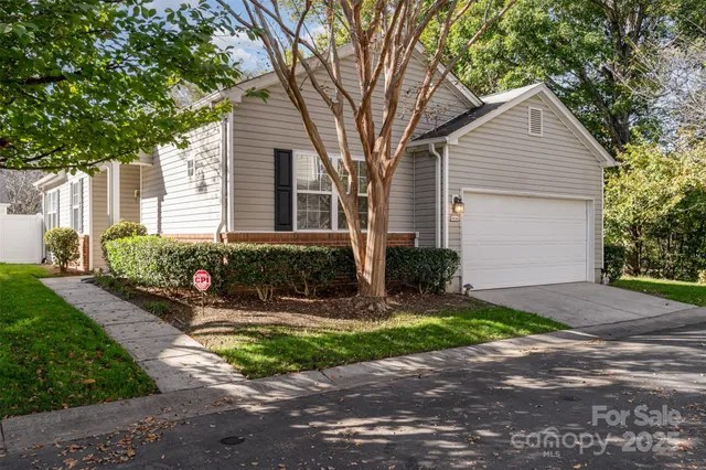 a front view of a house with yard and green space