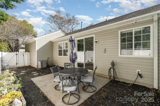 a backyard of a house with table and chairs