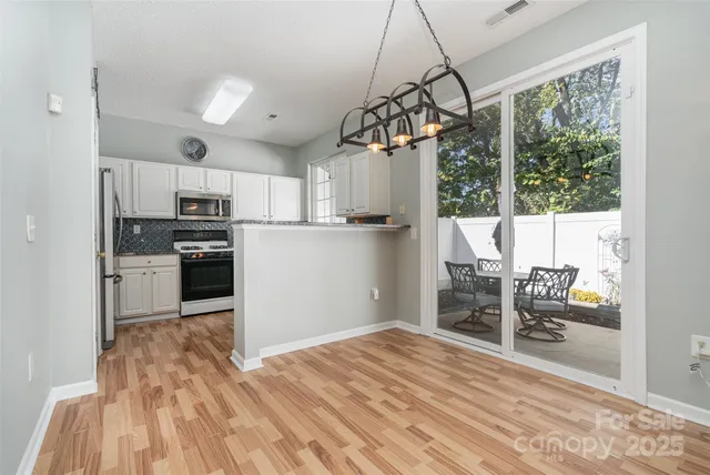 a kitchen with stainless steel appliances kitchen island granite countertop a refrigerator and microwave