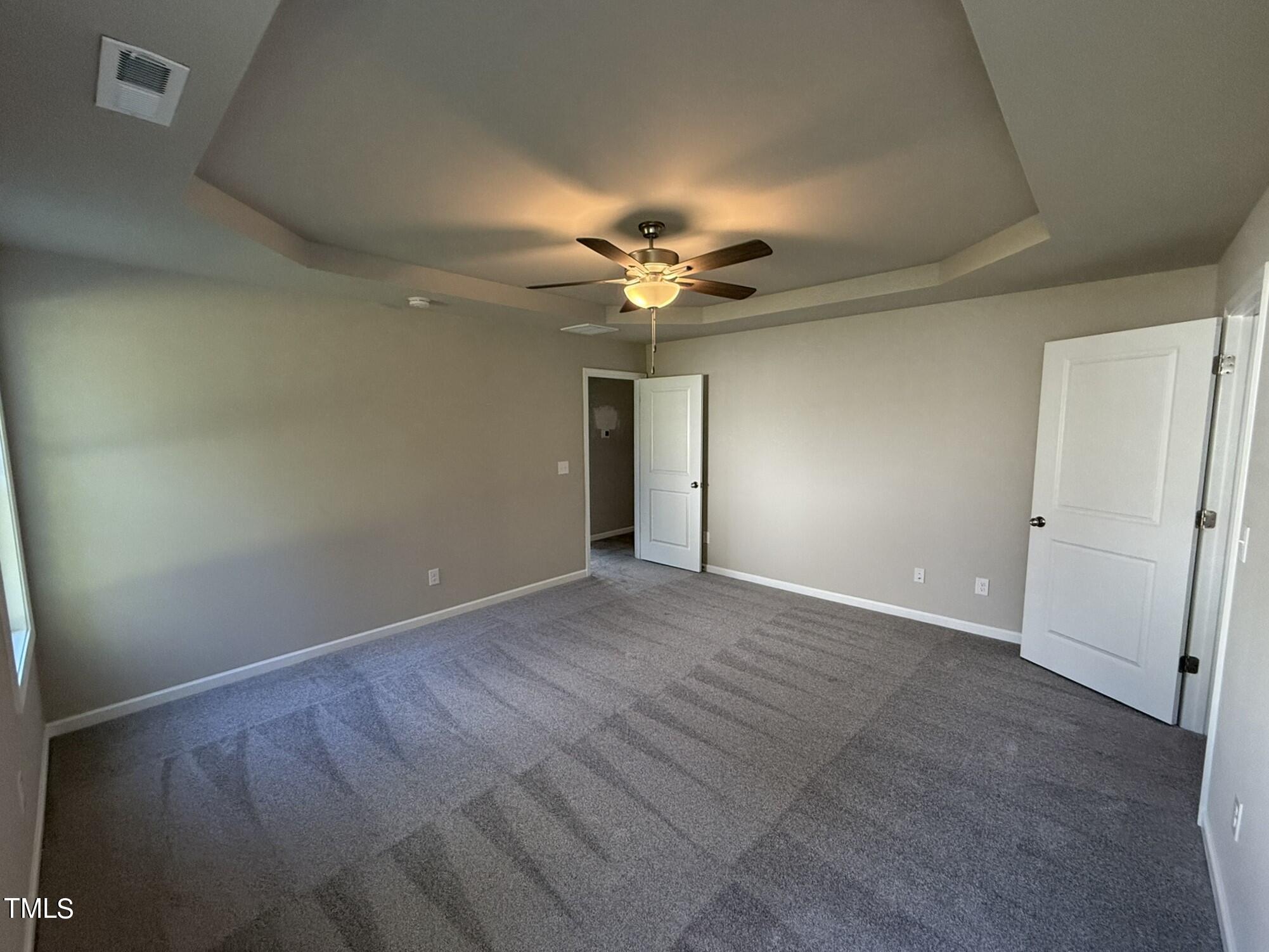 175 Grace Ridge Benson, NC 27504 - Photo 11 of 19 an empty room with a ceiling fan and a window