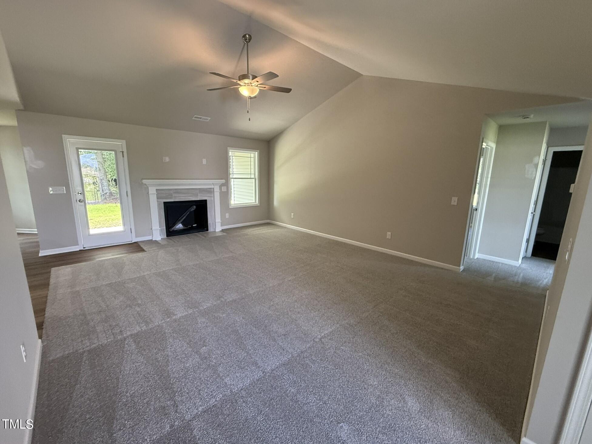 175 Grace Ridge Benson, NC 27504 - Photo 3 of 19 en empty room with windows and fireplace