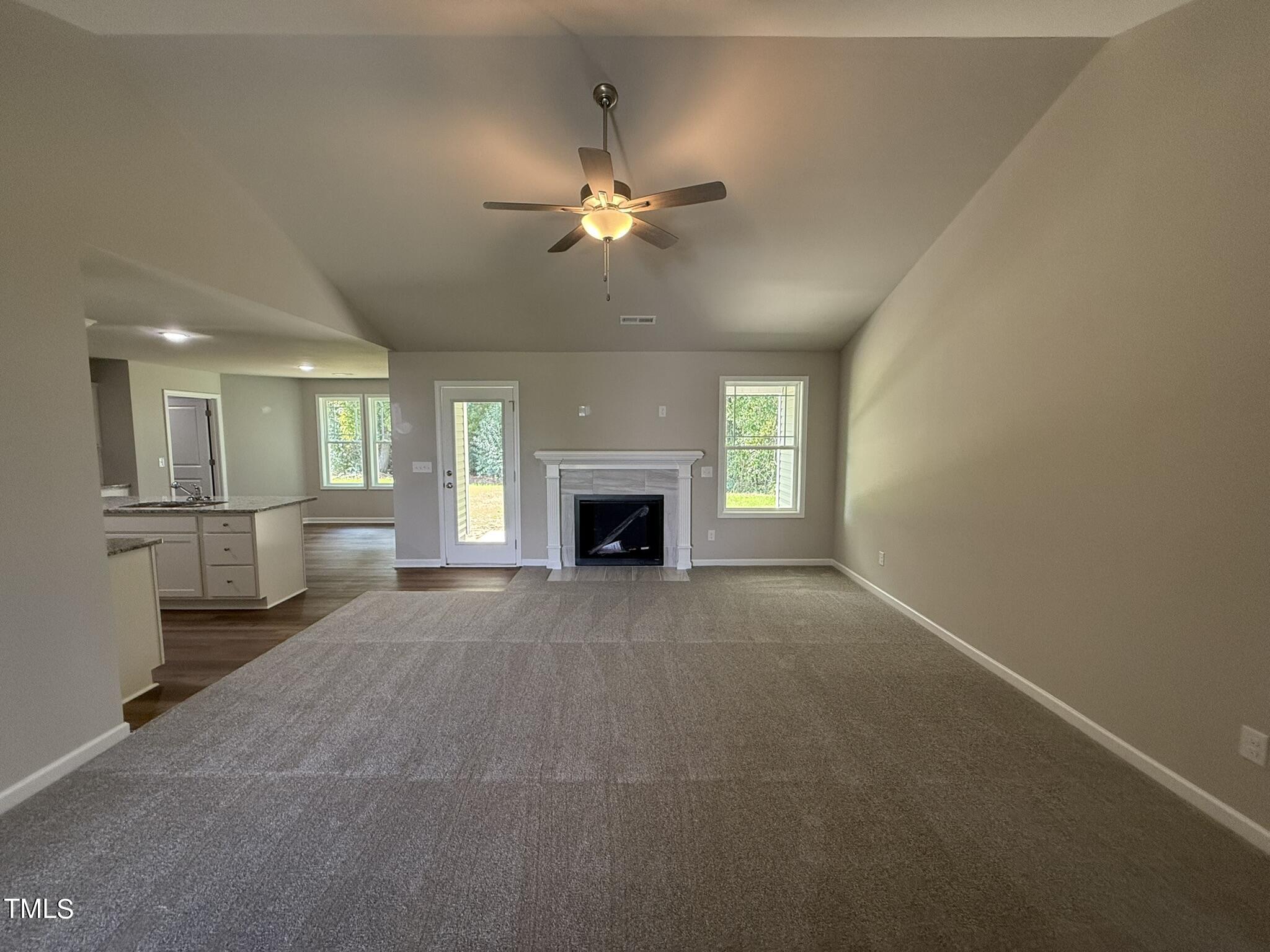 175 Grace Ridge Benson, NC 27504 - Photo 4 of 19 a view of a livingroom with a fireplace and a ceiling fan
