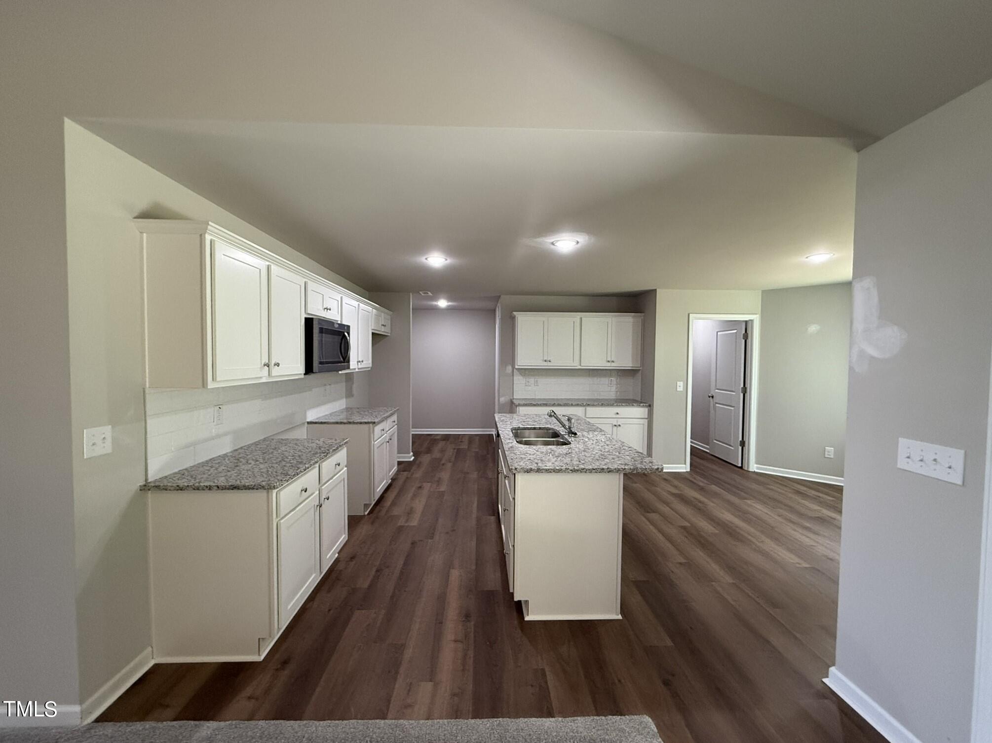 175 Grace Ridge Benson, NC 27504 - Photo 6 of 19 a large kitchen with stainless steel appliances a large counter top a stove and a refrigerator