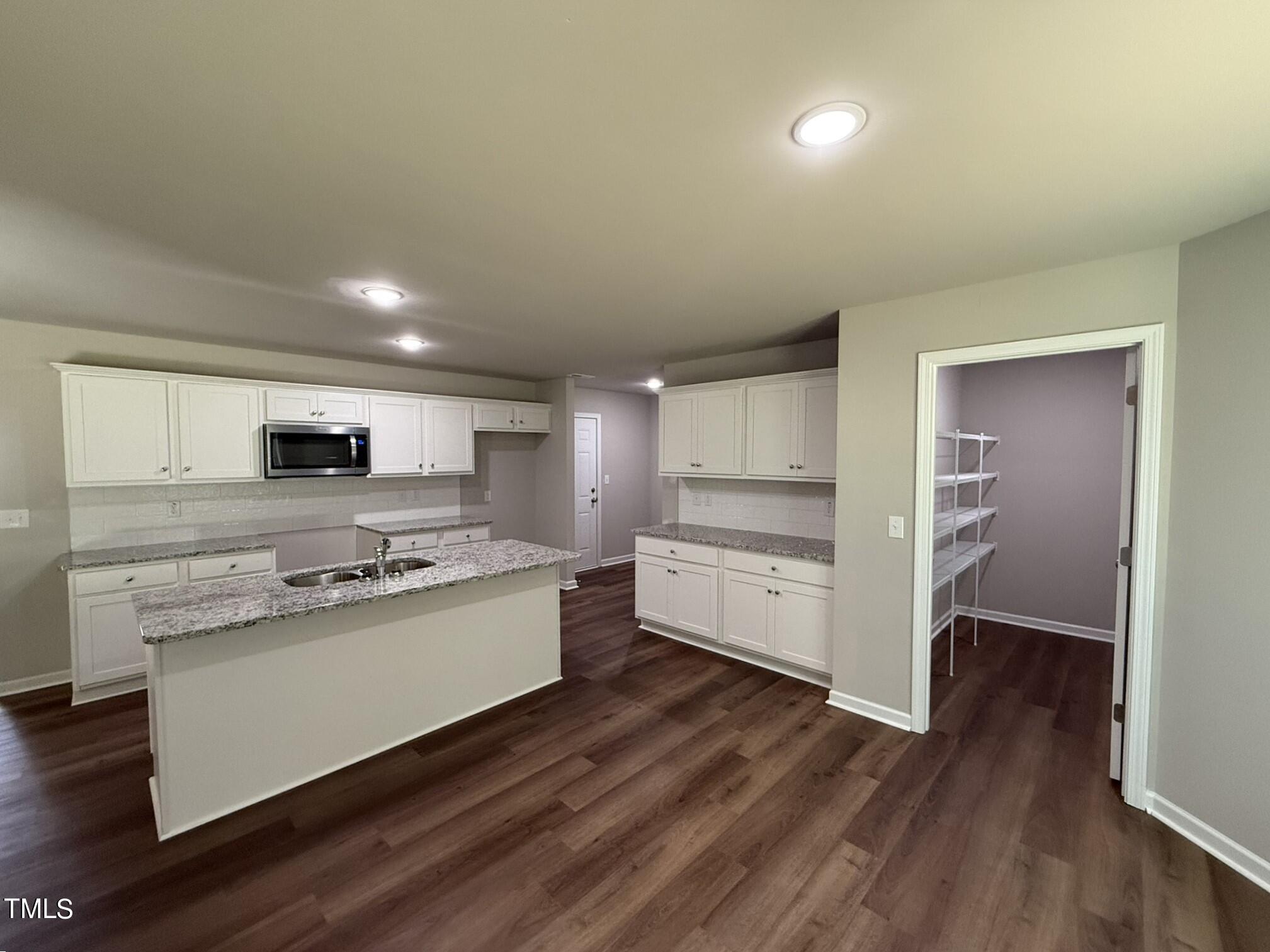 175 Grace Ridge Benson, NC 27504 - Photo 7 of 19 a kitchen with stainless steel appliances a stove top oven a sink and a refrigerator