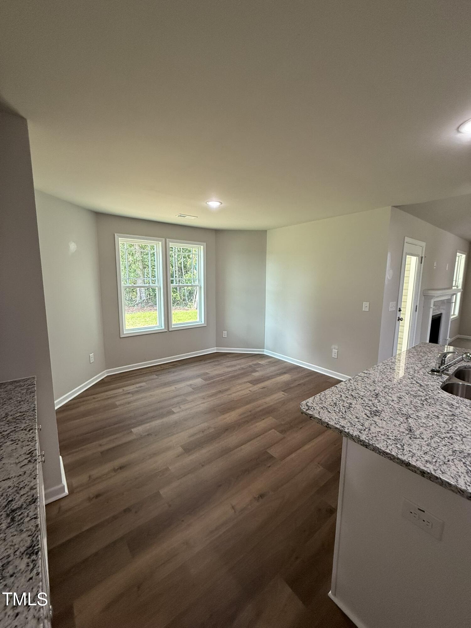 175 Grace Ridge Benson, NC 27504 - Photo 9 of 19 a view of a kitchen cabinets a sink wooden floor and a window