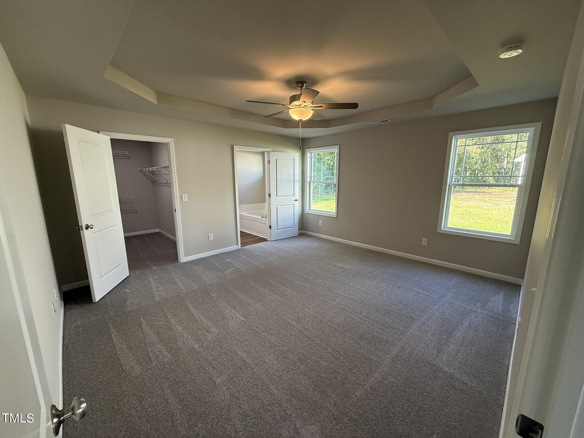 175 Grace Ridge Benson, NC 27504 - Photo 10 of 19 an empty room with windows and fan