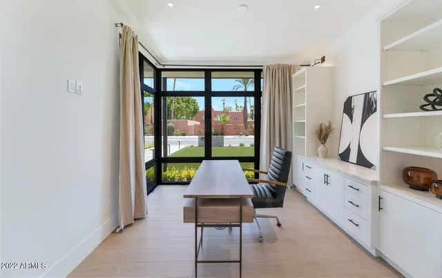 a view of a patio with table and chairs with wooden floor and fence