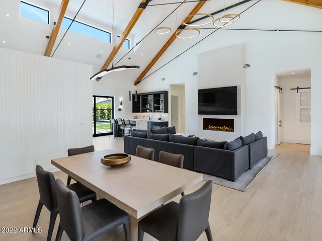 a view of a dining room with furniture and chandelier