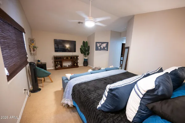 a bedroom with a bed and a flat screen tv