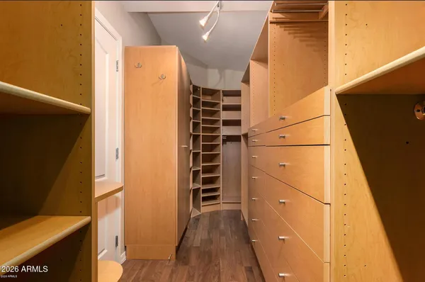 a view of walk in closet with empty racks