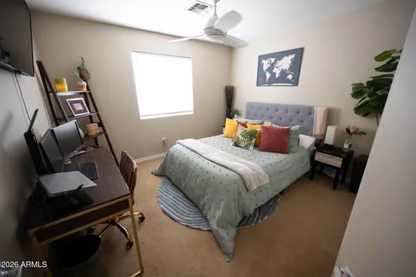 a bedroom with bed and a window