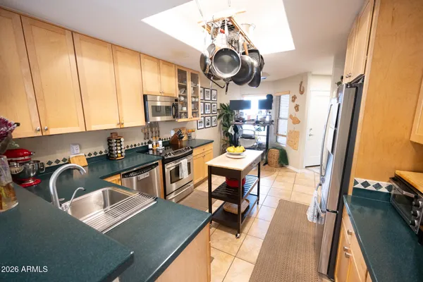 a kitchen with a sink appliances cabinets and furniture