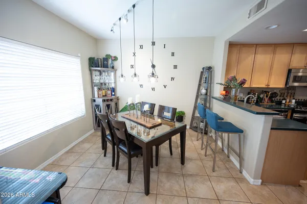 a dining room with furniture and a large window