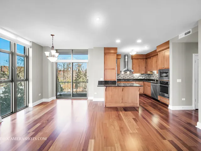 a large kitchen with kitchen island a large counter space a sink appliances and cabinets