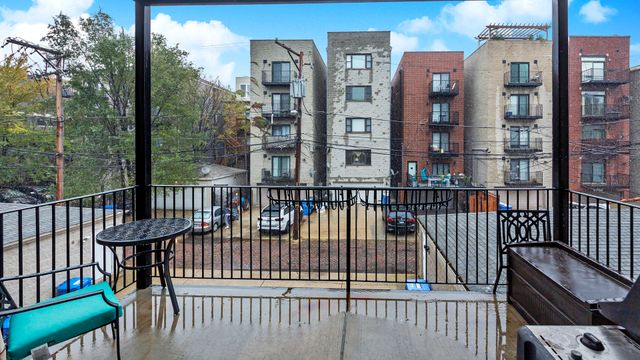 a view of a balcony with a floor to ceiling window and wooden floor