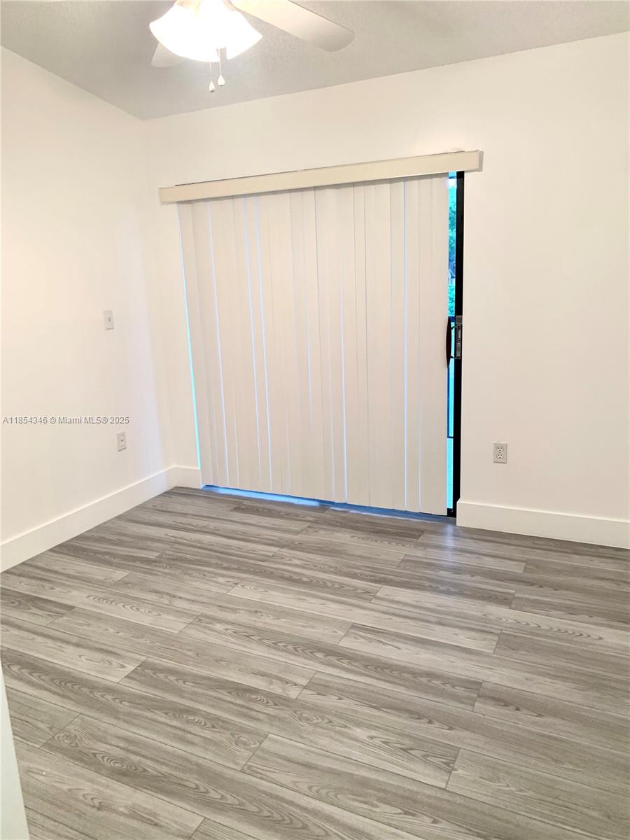 469 Northeast 207th Lane, Unit 207 Miami, FL 33179 - Photo 12 of 25 a view of a room with wooden floor