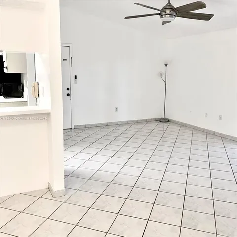 a view of a livingroom with an oven and white cabinets