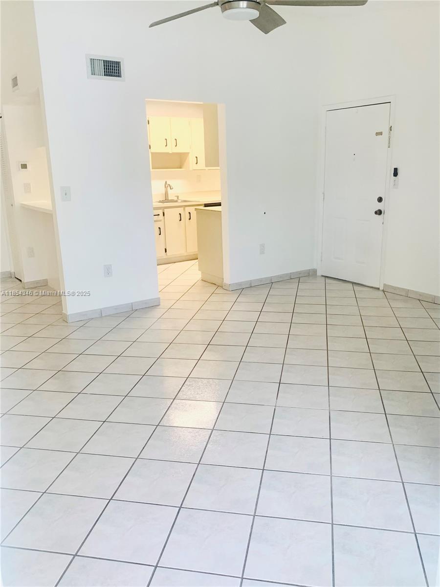 469 Northeast 207th Lane, Unit 207 Miami, FL 33179 - Photo 18 of 25 a view of a livingroom with an oven and white cabinets