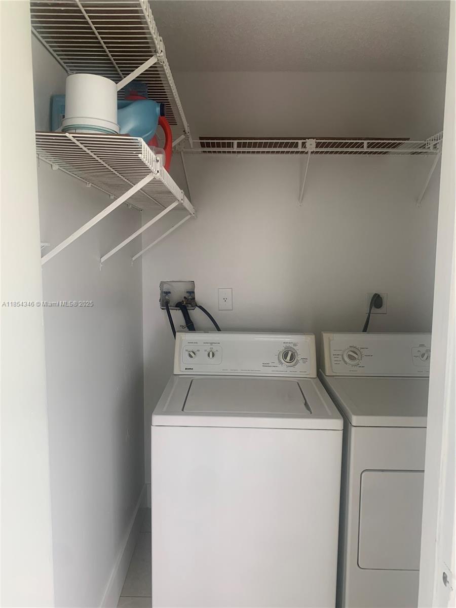 469 Northeast 207th Lane, Unit 207 Miami, FL 33179 - Photo 21 of 25 a utility room with dryer and washer