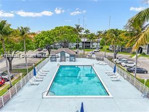 469 Northeast 207th Lane, Unit 207 Miami, FL 33179 - Photo 23 of 25 a swimming pool with outdoor seating and plants