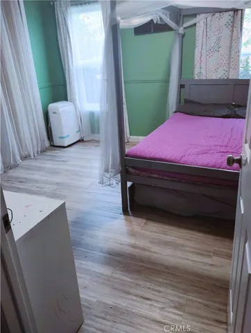 a bedroom with furniture and a window