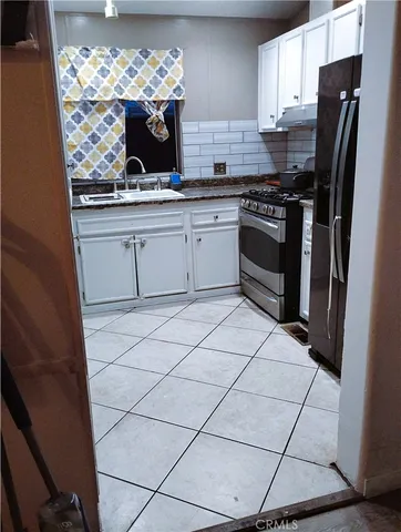 a kitchen with stainless steel appliances a stove a sink and a refrigerator