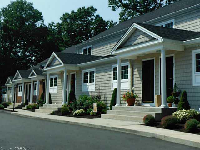 1163 Old Colony Road, Unit 15 Wallingford, CT 06492 - Photo 1 of 1 front view of a house with a yard