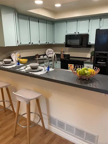 a kitchen with a sink a stove and a cabinets