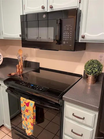 a stove top oven sitting inside of a kitchen