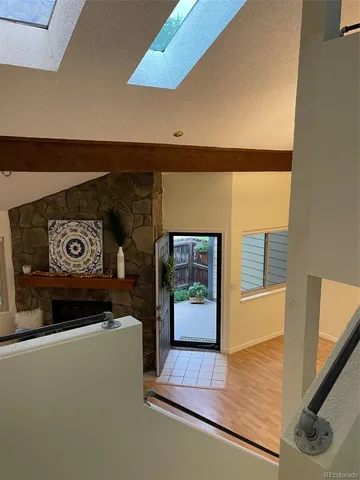 a view of a hallway with wooden floor and workspace