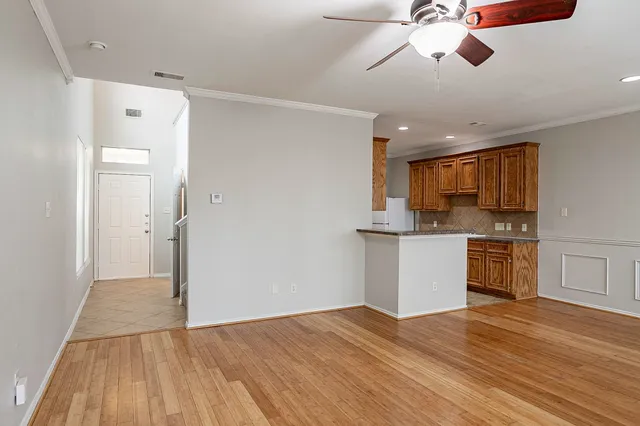 a view of a kitchen with a sink and dishwasher with wooden floor