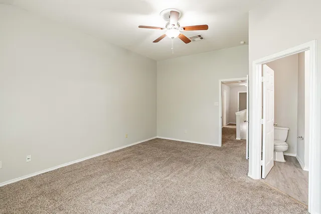 a view of an empty room and window with wooden floor