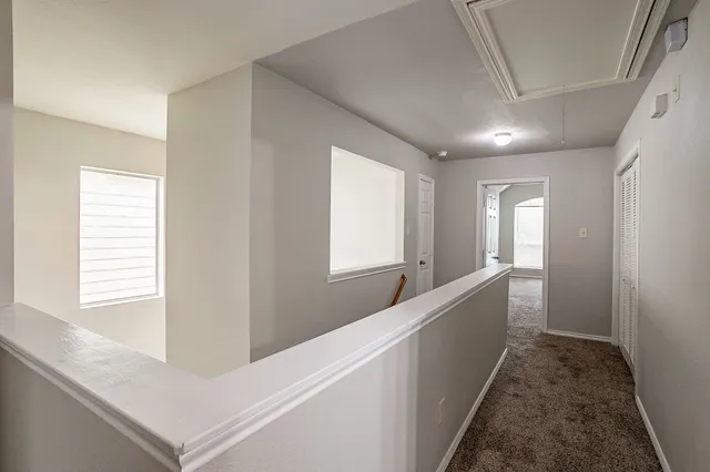 a view of hallway with windows