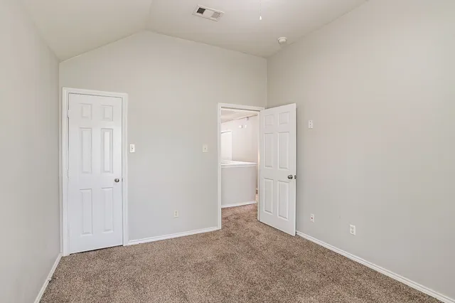 an empty room with closet area