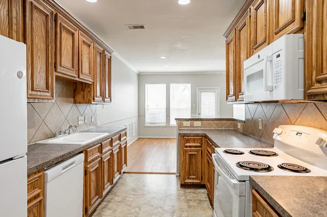 a kitchen with stainless steel appliances granite countertop a stove and a sink
