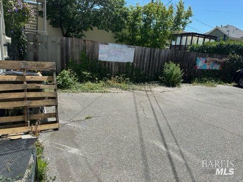 1547 4th Street, Unit A San Rafael, CA 94901 - Photo 6 of 64 a view of a backyard with potted plants and a large tree