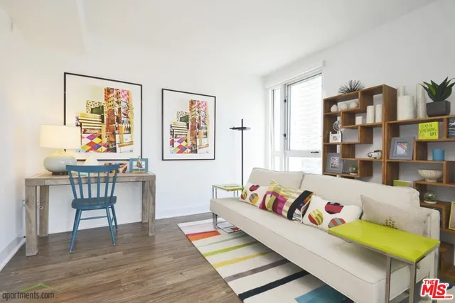 a living room with furniture and next to a window